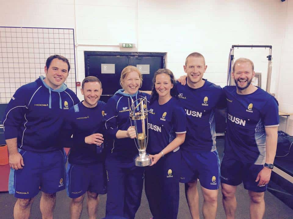 John Chaffe holding championship trophy with the medical team at Worcester Warriors