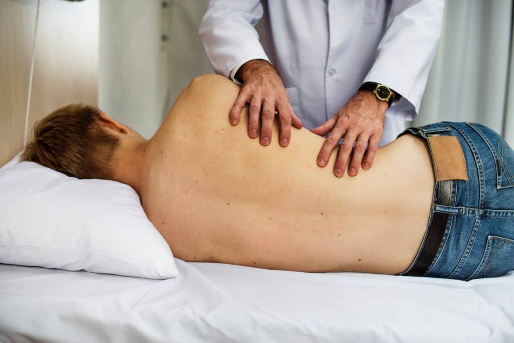 Man getting treatment by a doctor wearing jeans